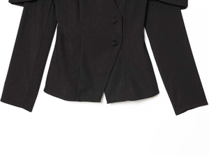 Detailed view of the tailored waist and fabric texture on this slim fit black blazer