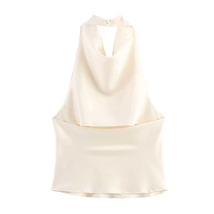 Close-up of cream satin halter top featuring a draped neckline and smooth silk texture