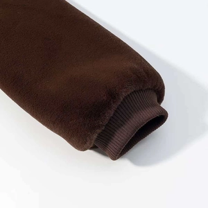 Detail of dark brown faux fur sleeve with elastic ribbed knit cuff for windproof protection