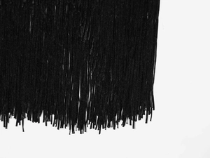Detailed close-up of high-quality black fringe tassels with vertical texture and dense finish