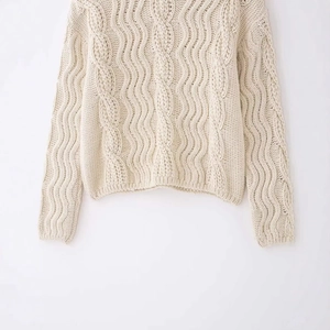 Women's cream white turtleneck cable knit sweater with chunky cable stitching texture