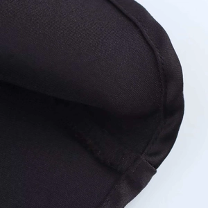 Macro shot of precise edge stitching and texture on black sleeveless dress fabric