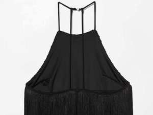 Detail of black halter dress featuring delicate straps and dense fringe textures