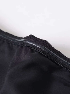 Detail shot of the non-slip silicone strip on the black strapless midi dress inner edge