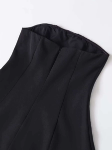 Detail of black strapless midi dress showing a seamless invisible back zipper closure