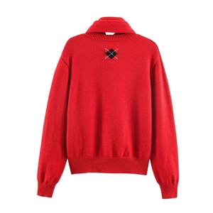 Detailed back view of red knit cardigan featuring classic argyle pattern embroidery