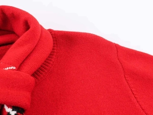 Detailed macro view of the red knitted cardigan collar with fine ribbing texture