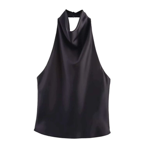 Detail of elegant black silk halter top featuring cowl neck and smooth satin texture