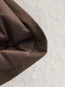 Close-up of the professional stitching and brown inner lining on this autumn trench coat