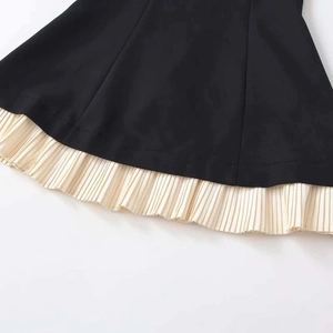 Elegant black midi dress with off-shoulder neckline and cream pleated hem detail
