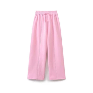 Detail of pink wide-leg sweatpants with elastic drawstring waist and center seam stitching