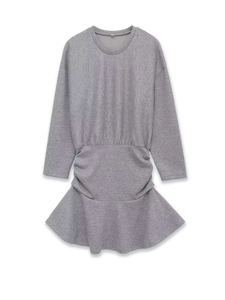 Detail of grey knitted dress featuring waist pleats and a ruffled fishtail hemline