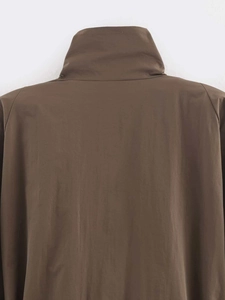 Detail view of the high-collar back and shoulder stitching on a brown minimalist coat