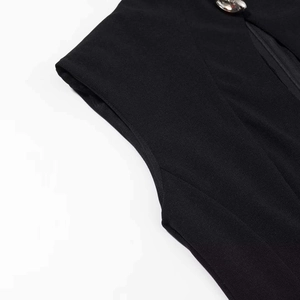 Detail of slim fit black dress showing stand collar with crystal button and hidden zipper