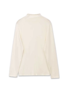 Close-up detail of cream white turtleneck top showing smooth pleated knit fabric texture