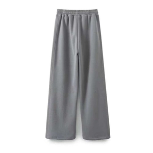 Detail of grey wide-leg sweatpants with elastic waistband and soft cotton fabric