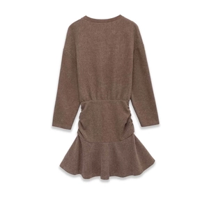 Detail view of brown long sleeve knitted dress with waist cinching and fishtail hemline