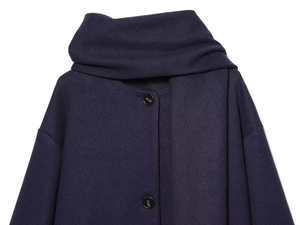 Close-up of high-quality navy wool jacket featuring a stylish scarf collar and textured buttons