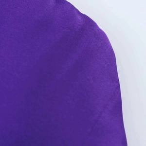 Detail shot of the smooth purple silk texture fabric and shoulder seam construction