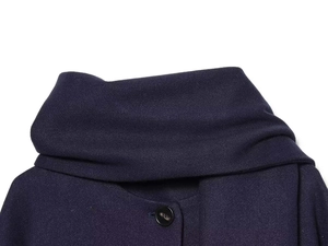 Detail view of the vintage scarf collar and matte button on dark wool blend coat