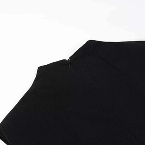 Detail of the invisible back zipper on a black slim-fit dress with stand collar