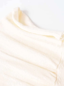 Macro shot of off-white faux wool fabric featuring fine horizontal pleated textures