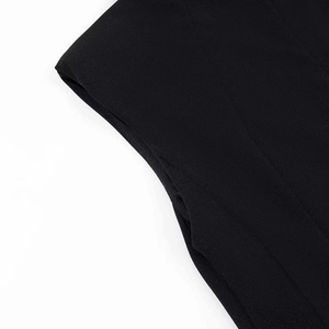 Detail view of black slim-fit dress showing shoulder texture and sleeveless cut