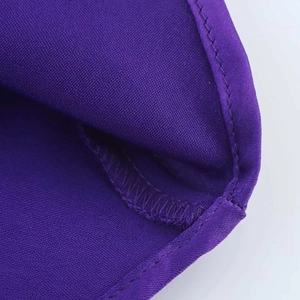 Detailed close-up of neat hem stitching on premium dark purple satin fabric