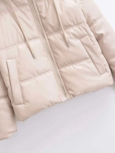 Detail of beige faux leather puffer jacket featuring a metal zipper and hooded drawstring
