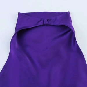Detail of purple silk halter top showing smooth satin texture and precision stitching
