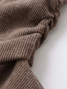 Detailed macro view of the premium dark brown ribbed knit fabric texture and quality