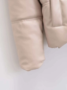 Close-up of beige faux leather puffer jacket showing quilted texture and premium PU material