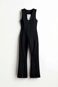 Detail of slim-fit black sleeveless jumpsuit with V-neckline and functional zippers