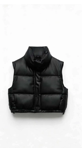 Detail of black puffer vest featuring a stand collar and adjustable drawstring hem