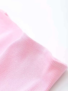 Close-up of pink ribbed knit fabric showing soft texture and elastic vertical weave