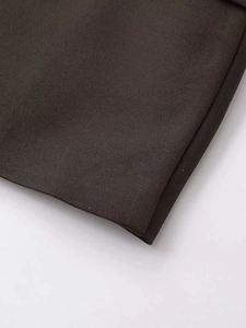 Close-up of the professional stitching and dark coffee twill fabric texture on blazer hem