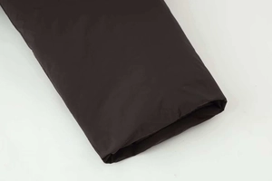 Detail of windproof puffer jacket cuff with drawstring and water-resistant fabric