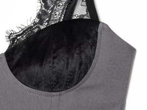 Close-up of grey twill fabric with black velvet bodice and delicate eyelash lace detail