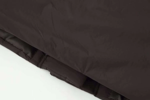 Detailed macro view showing the quilted fabric texture and stitching of the winter puffer coat