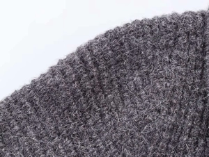 Detail shot of premium dark grey knit fabric featuring a soft brushed wool texture