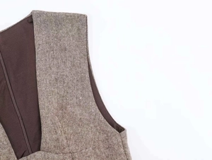 Close-up of wool blend dress back featuring a hidden zipper and textured tweed fabric