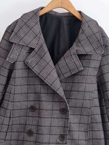 Detail shot of vintage plaid cropped blazer showing lapel collar and double-breasted buttons
