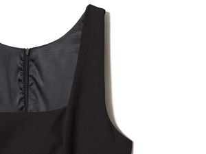 Close-up detail of a black sleeveless dress featuring a seamless invisible back zipper