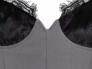 Detailed close-up of dark grey woven fabric with black velvet trim and eyelash lace edges