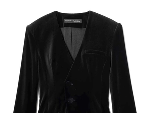 Detailed macro view of black velvet texture and wrapped buttons on minimalist V-neck blazer