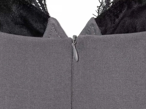 Detail of grey twill dress featuring delicate black lace trim and hidden zipper closure