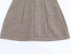 Detail view of wool blend fabric texture and stitching on an A-line skirt hem