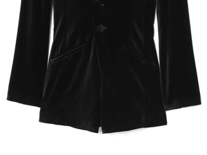 Detailed view of black velvet blazer romper featuring button closure and side pockets