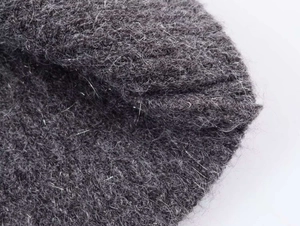 Detailed close-up of dark grey mohair knit fabric showing soft texture and premium fibers
