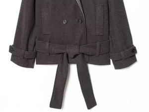 Detail view of charcoal wool coat featuring double-breasted buttons and tied waist belt